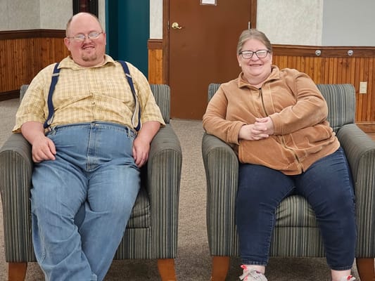 Two residents seated in a common area