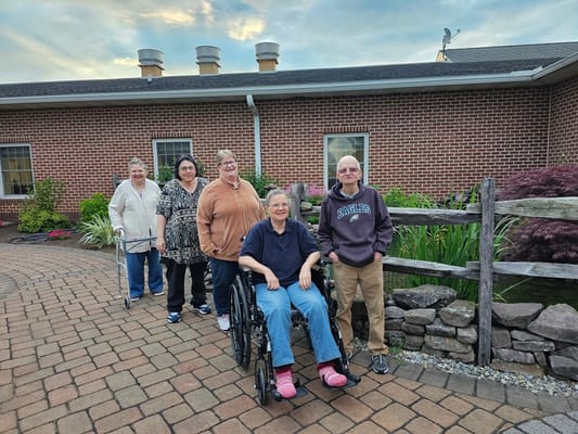 Residents enjoying time outdoors in a garden pathway