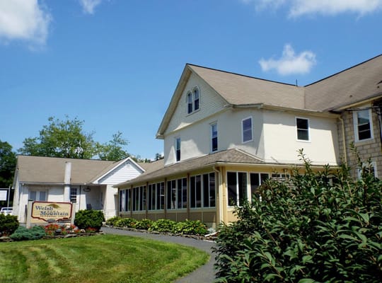 Exterior view of Welsh Mountain Home facility with sign