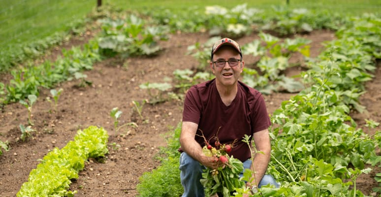 Resident harvesting vegetables in a garden