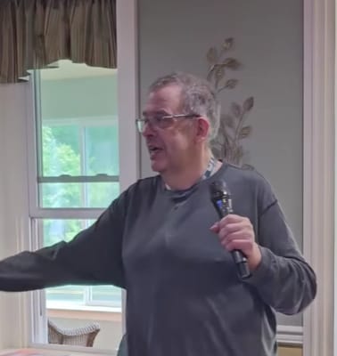 A resident speaking into a microphone in a common area