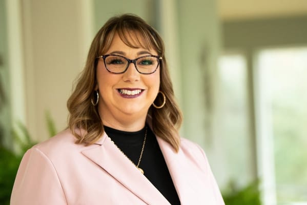 Staff member smiling in a bright interior space