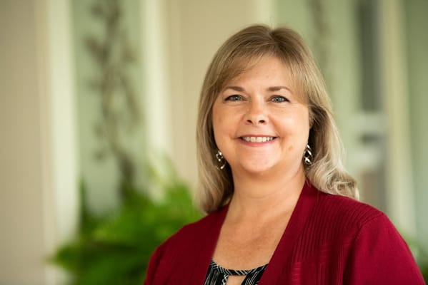 Staff member smiling warmly at the camera