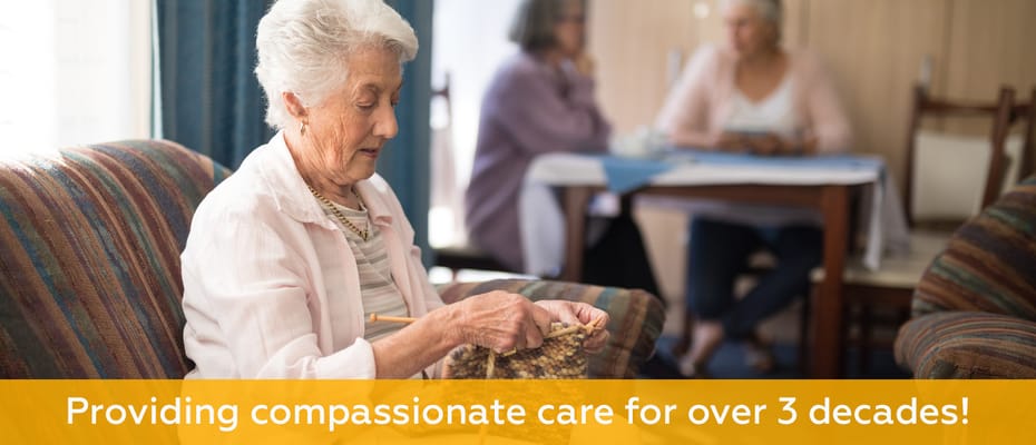 Resident knitting in a cozy common area