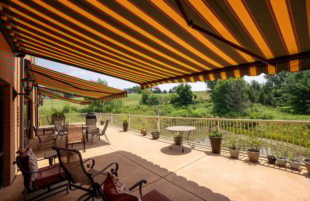 Patio area with striped awnings and comfortable seating