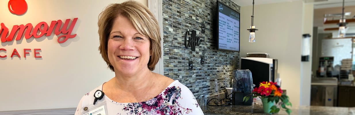 Staff member smiling in the café area