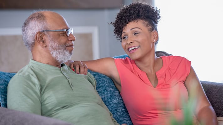 A resident and staff member sharing a joyful moment