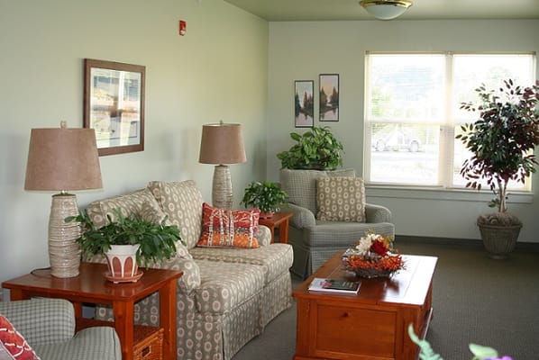 A cozy lounge area with seating and plants