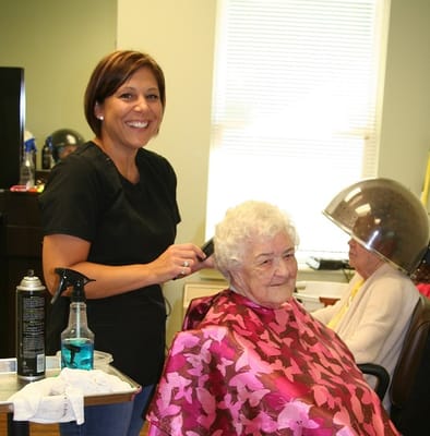 Resident receiving a haircut in a common area
