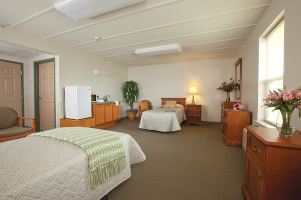 Well-furnished private resident room with beds and amenities