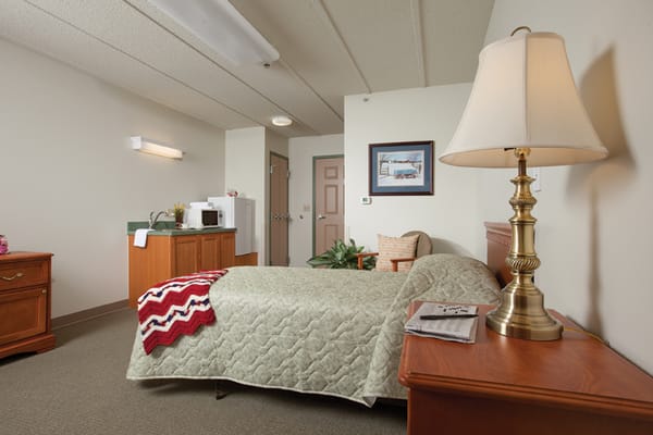 Cozy resident room with bed and amenities