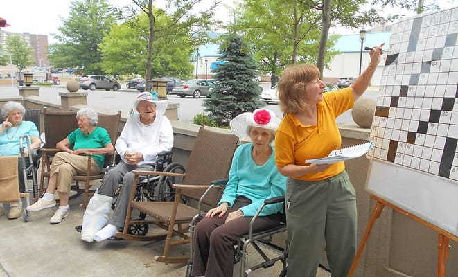 Residents participating in an outdoor crossword activity