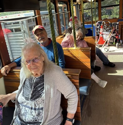 Residents enjoying a ride on a facility tram