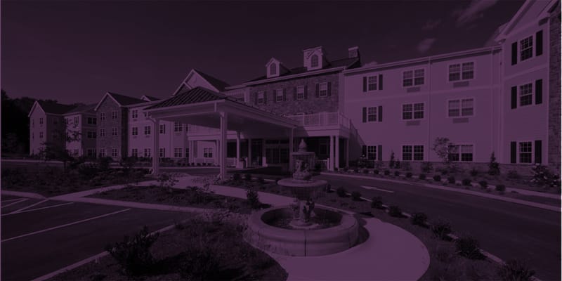 Exterior view of a senior living facility with landscaping