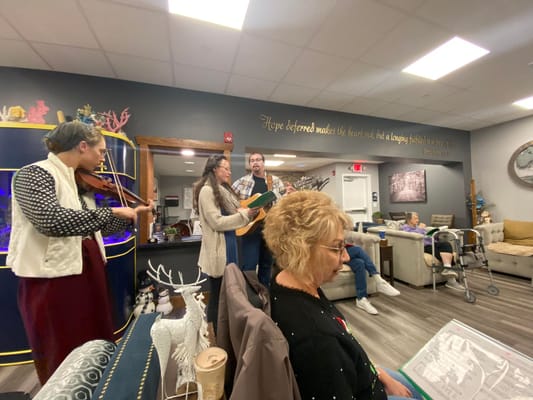 Residents enjoying a musical performance in the common area