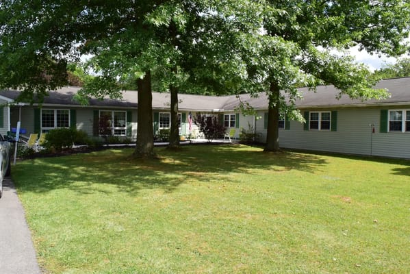 Outdoor view of a nursing home facility surrounded by trees