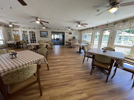 Dining area with tables and chairs in a bright setting