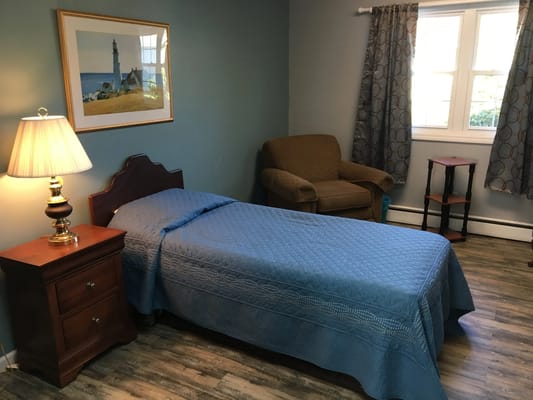 Private resident room with a single bed and lamp