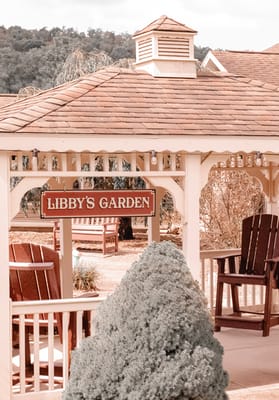 Outdoor garden area with seating and a sign