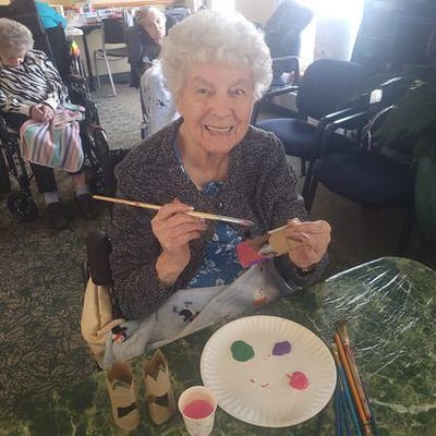 Resident painting during a group activity in the common area