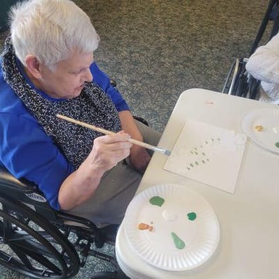 Resident painting during an art activity session