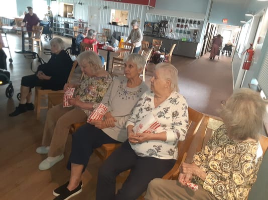 Residents enjoying popcorn in a common area