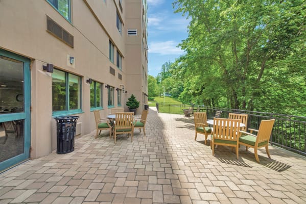 Outdoor seating area with patio furniture and greenery