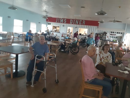 Residents interacting in the dining room of the facility