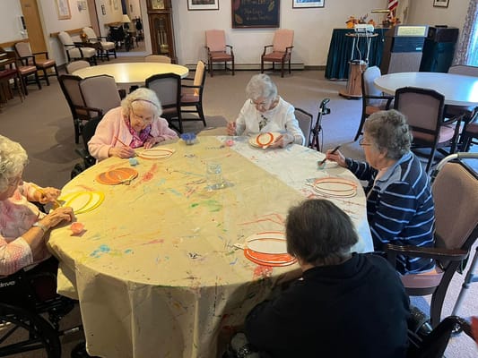 Residents engaged in a creative activity at a communal table