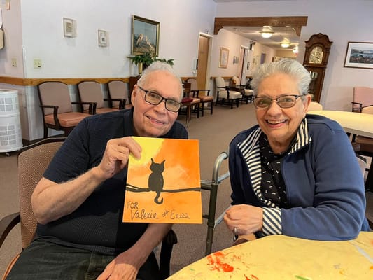 Residents showing artwork in common area