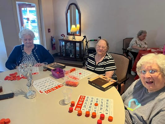 Residents enjoying a game of bingo at a table
