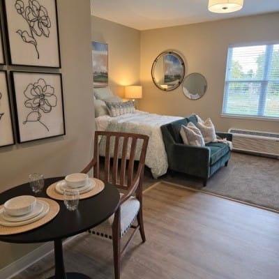 Cozy resident room with a bed and sitting area