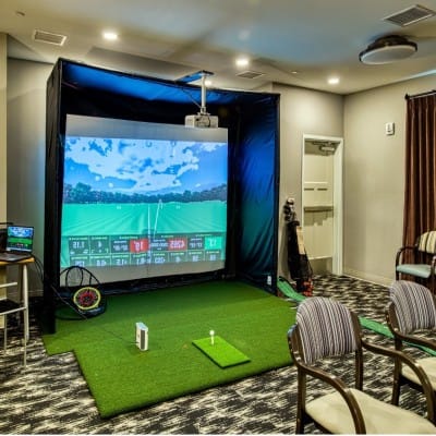 Indoor golf simulation setup in a recreation room