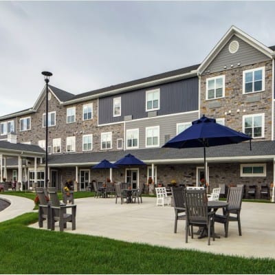 Outdoor seating area with umbrellas and a building facade
