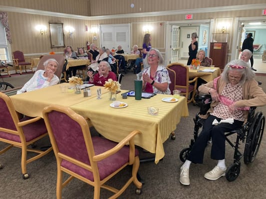 Residents enjoying a lively activity in the dining area