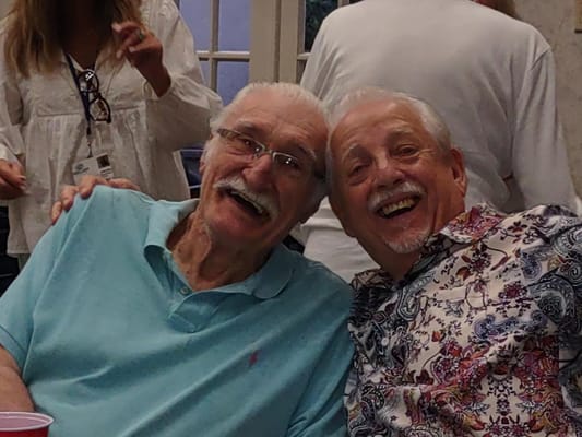 Two male residents smiling and enjoying each other's company