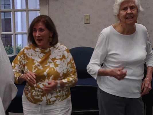 Residents enjoying a dance activity in a common area
