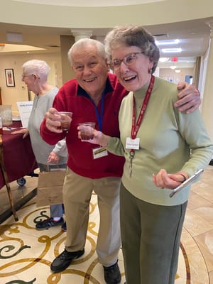Residents celebrating with drinks in a common area