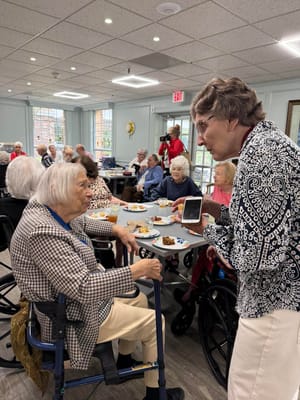 Residents enjoying a meal and conversation in the dining area