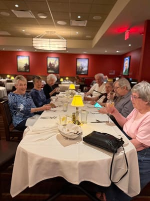 Residents enjoying dinner at a dining table
