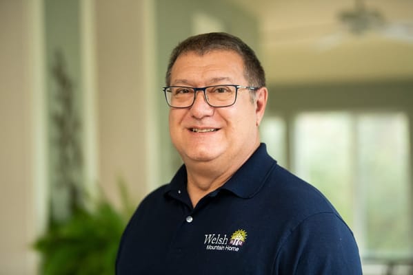 Staff member posing in a bright common area