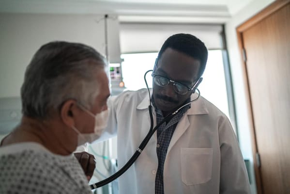 A doctor examining a senior patient in a medical setting