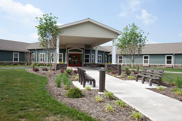 Front entrance of Wolf Run Village with landscaped pathway