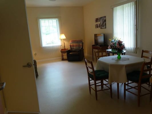 Cozy resident room with a dining table and seating area