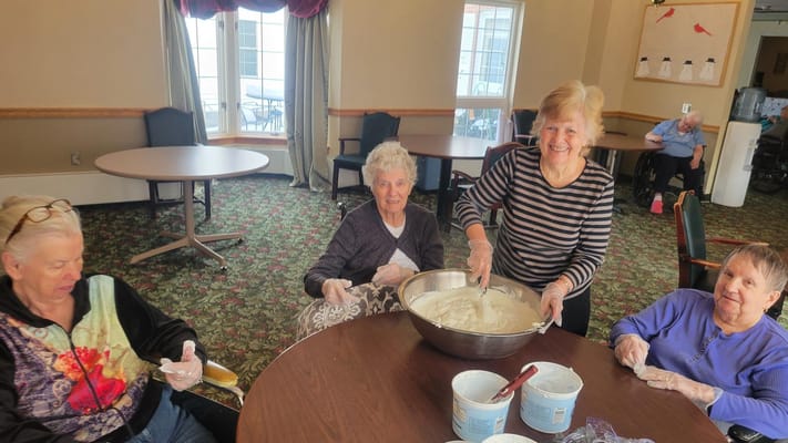 Residents enjoying a cooking activity in the common area