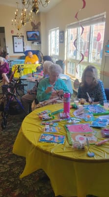 Residents participating in a craft activity in a common area