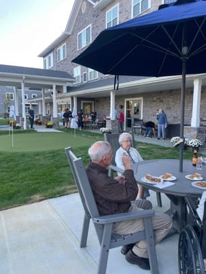 Residents enjoying a meal outdoors at a dining area