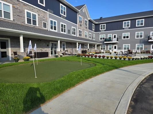 Beautiful outdoor space with golf putting green and flowers