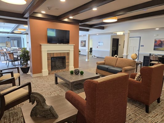 Interior common area with seating and a fireplace