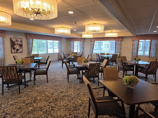 Bright dining room with tables and floral centerpieces